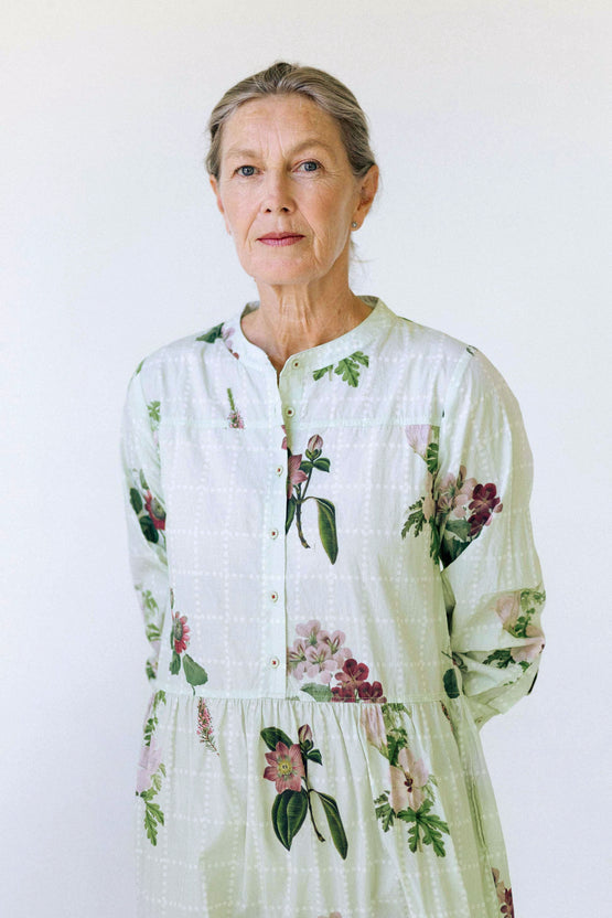 Ingrid dress in botanical print, worn by an older woman with grey hair