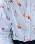 A close up of the botanicals wildflower print. The shirt has a pale blue background