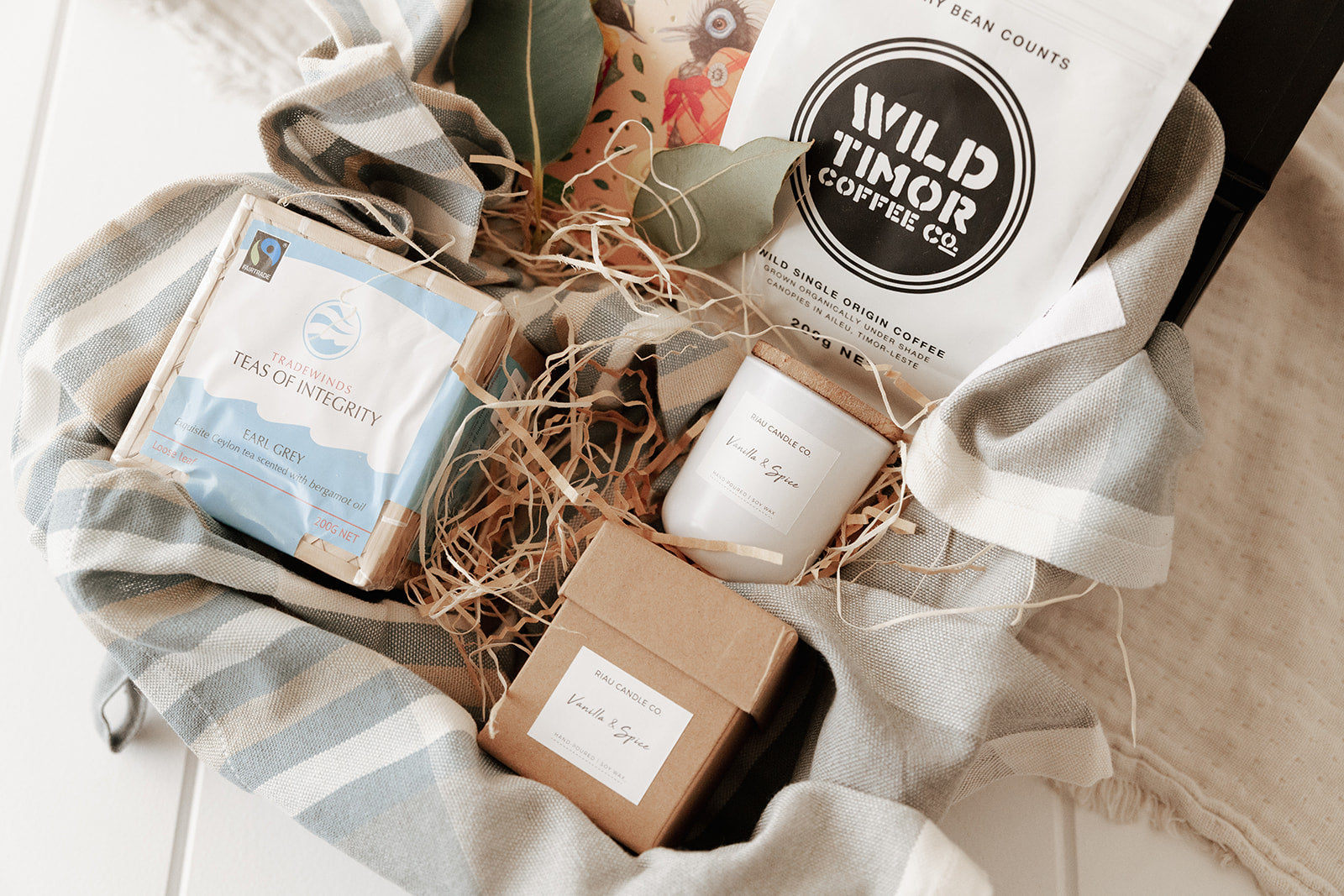 Ethical corporate hamper with tea, coffee, chocolate, candle and tea towel